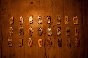 Bone or antler rune set on wooden surface, warm and organic
