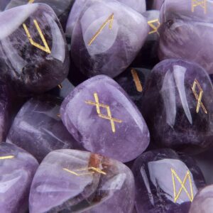 Stone rune set on natural background, cool-toned and grounded