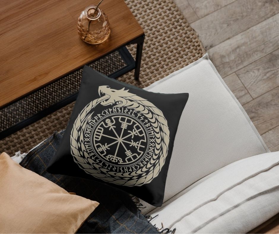 Black Norse Vegvisir pillow cover on a light sofa in a cozy dark Nordic living room